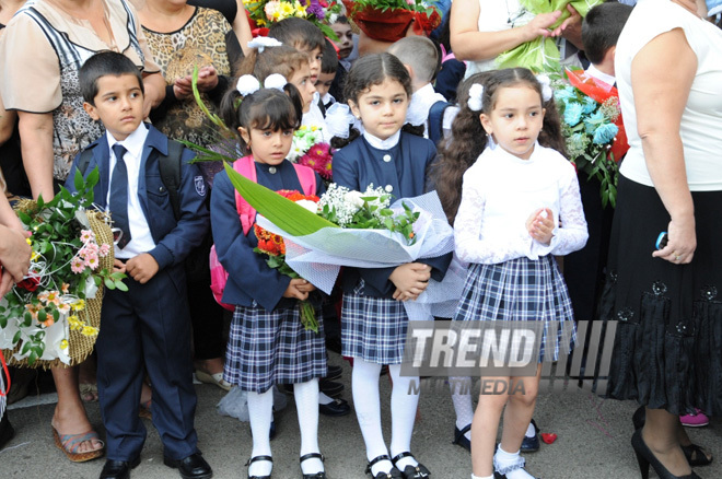 Knowledge Day is the first bells and excitements, bunch of flowers and white bows. Baku, Azerbaijan, Sept.16, 2013