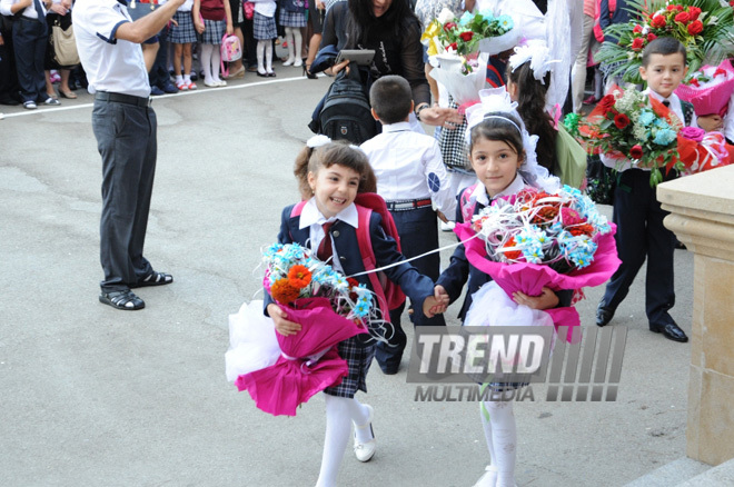 Knowledge Day is the first bells and excitements, bunch of flowers and white bows. Baku, Azerbaijan, Sept.16, 2013